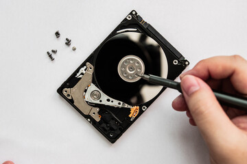 Hard drive being disassemble for data recovery. Data recovery and backup concept.
