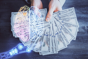 Multi exposure of brain drawing hologram and us dollars bills and man hands. Ai invest concept