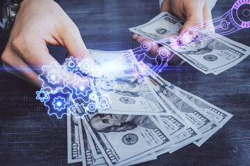 Multi exposure of technology drawing hologram and us dollars bills and man hands. Data concept