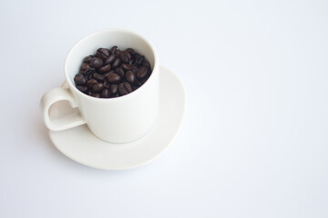 Coffee beans in white coffee cup on white background.
