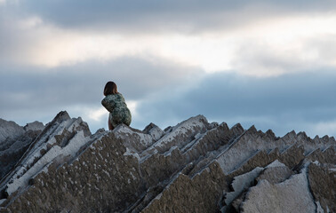 girl posing on a ridge of rocks