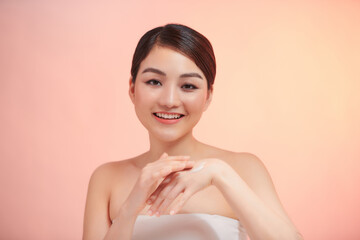 Woman applying moisturizing cream on hands