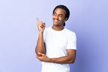 Young African American man with braids man isolated on purple background pointing up a great idea - obrazy, fototapety, plakaty