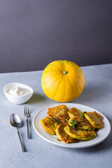 Vegetable veggie pumpkin pancakes with sour cream, summer food, delicious snacks. Pumpkin pancakes. Healthy food concept