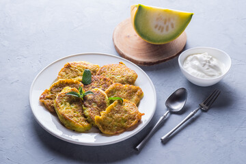 Vegetable veggie pumpkin pancakes with sour cream, summer food, delicious snacks. Pumpkin pancakes. Healthy food concept