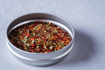 A mixture of different spices in a jar close-up on a gray background. spices and seasonings