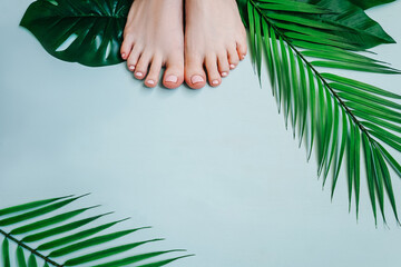 Female pedicure on blue background, top view. - obrazy, fototapety, plakaty