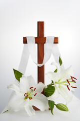 Cross with lilies on white background. Spring background. Easter, baptism or first communion concept