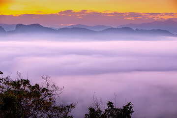 The mountain covered by sea of fog on the morning have twilight ray on sky.