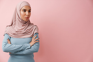 A confident muslim woman in pink hijab looking to the side