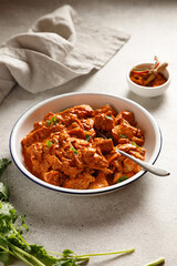 Chicken paprikash dish with paprika onion bulgarian paper on plate on light table for dinner