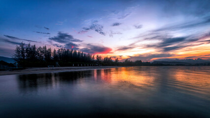 Fototapeta na wymiar a sunset over a body of water