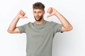 Fototapeta premium Young caucasian handsome man isolated on white background proud and self-satisfied