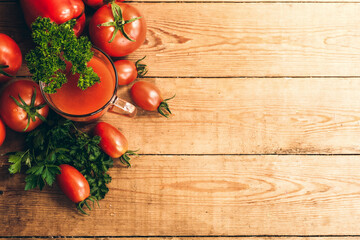 Red pepper and fresh tomatoes on a wooden table. Tomato juice with salt.