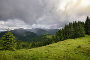 Wonderful summer panorama with mountains. A thunderstorm is coming. Rain Clouds Above Mountains....