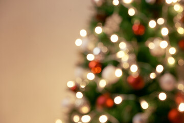 Fototapeta na wymiar Decorated Christmas tree on blurred, sparkling and fairy background