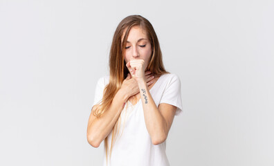 pretty thin woman feeling ill with a sore throat and flu symptoms, coughing with mouth covered
