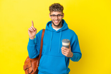 Young student blonde man isolated on yellow background pointing up a great idea