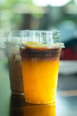 A glass of iced black coffee mix with orange juice