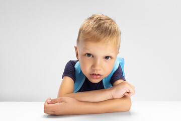 Close-up Caucasian preschool boy isolated on white studio background. Copyspace for ad. Childhood, education, emotion concept