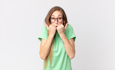 pretty thin woman looking worried, anxious, stressed and afraid, biting fingernails and looking to...