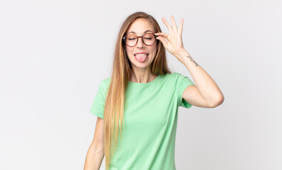 pretty thin woman smiling happily with funny face, joking and looking through peephole, spying on...