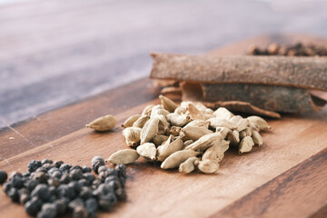 Spices and herbs on chopping board on table, top view 