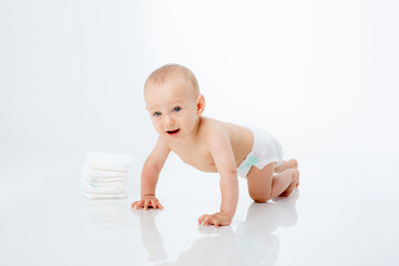 Funny baby in a diaper  crawling on white background .Changing baby diapers and skin care.