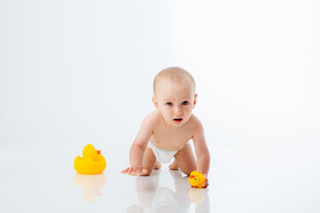baby boy in a diaper crawling on a white background isolated