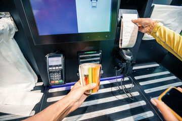 Scanning and paying for a vegetarian lunch at a self-service vending machine in a modern supermarket