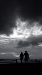 Fototapeta na wymiar Couple Walking at Beach While Cloudy Dark Sunset Monochrome