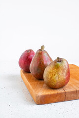 Ripe organic red pears on white stone background. Fresh pear closeup.
