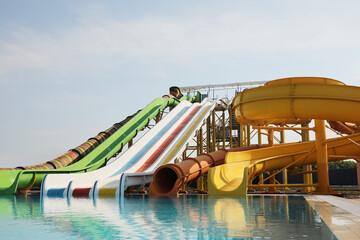 Beautiful view of water park with colorful slides and swimming pool on sunny day