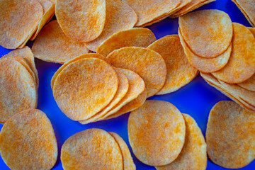 Potato chips isolated on blue background