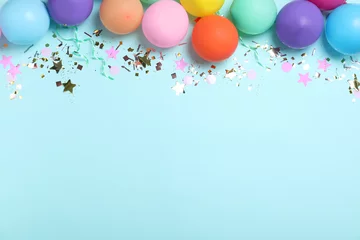 Gardinen Flat lay composition with balloons and confetti on light blue background, space for text. Birthday decor © New Africa