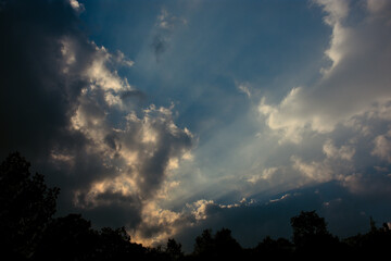 Fototapeta na wymiar Clouds and sunrays in the sky