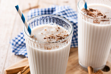 Fresh horchata with cinnamon in glass on rustic wooden table	
