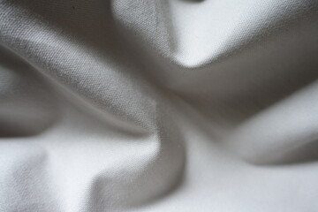 Soft folds on simple unprinted  light gray cotton fabric