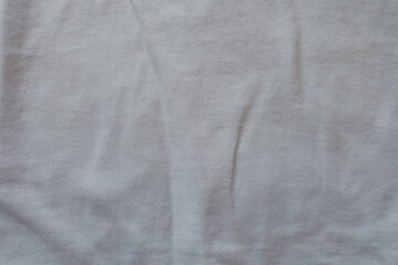 Creased simple white cotton jersey fabric from above