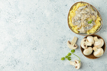 Bowl with tasty mashed potatoes and mushrooms on table