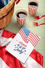 Fototapeta premium Greeting card for Independence Day and American flag with picnic basket on table