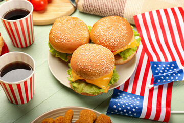American flags with traditional food on color wooden background