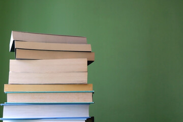 Stack of books with blue and green covers. Selective focus.
