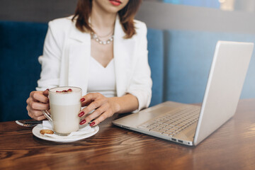Young businesswoman working with modern devices, digital tablet computer and mobile phone with coffee. New technologies for success workflow concept
