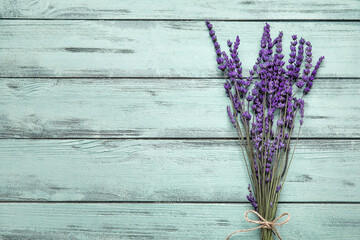 Beautiful lavender flowers on color wooden background © Pixel-Shot