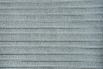 Surface of simple white ribbed cotton fabric from above