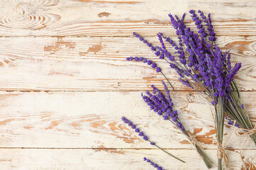 Beautiful lavender flowers on light wooden background