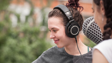 Behind the scene. Sound boom operator resting on the set and hold microphone fisher outdoor © guruXOX