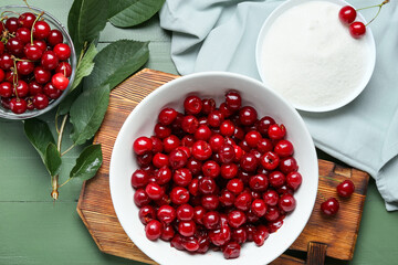 Composition with bowl of cherry and sugar on color wooden background