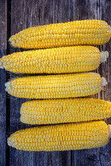 juicy ripe yellow corn on wooden background